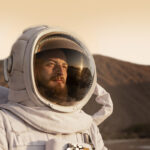 7male astronaut looking sun space mission another planet